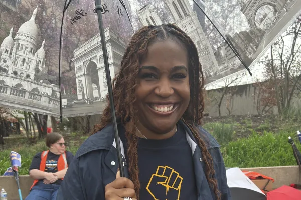 A woman at an AFGE rally wearing a Our Rights | Our Voice | Our Right shirt